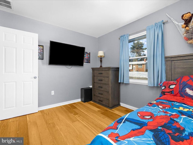 bedroom with hardwood / wood-style flooring