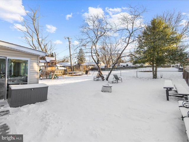 snowy yard with a playground