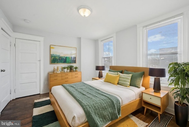 bedroom with dark wood-type flooring