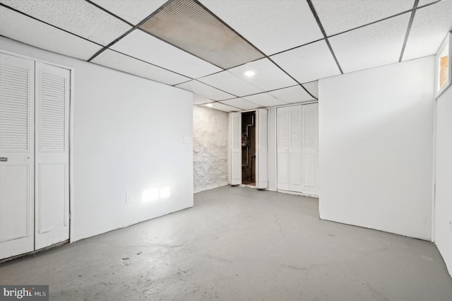 basement with a paneled ceiling