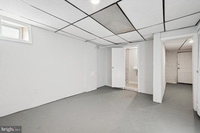 basement with a paneled ceiling