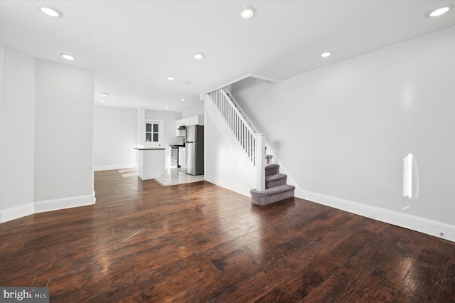 unfurnished living room featuring dark hardwood / wood-style floors