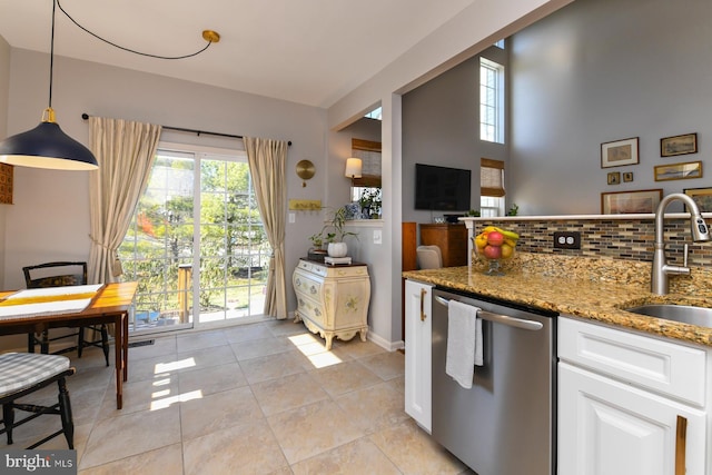 kitchen featuring white cabinetry, decorative light fixtures, dishwasher, stone counters, and sink