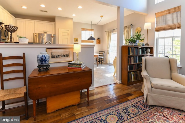 sitting room featuring hardwood / wood-style floors and a healthy amount of sunlight