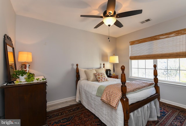 bedroom with ceiling fan and dark hardwood / wood-style flooring