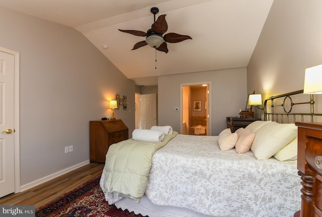 bedroom featuring ceiling fan, lofted ceiling, connected bathroom, and dark hardwood / wood-style floors