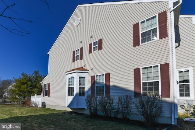 rear view of house with a yard