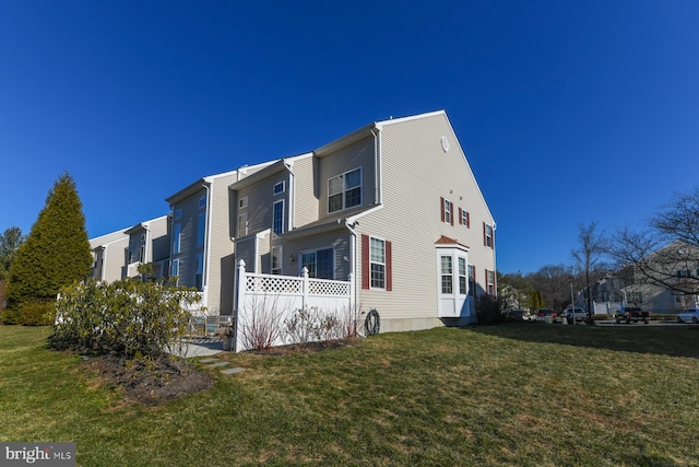 view of property exterior with a yard