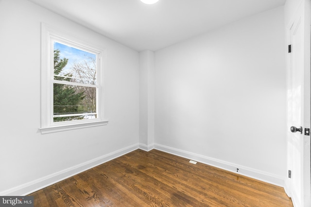 empty room with dark hardwood / wood-style floors