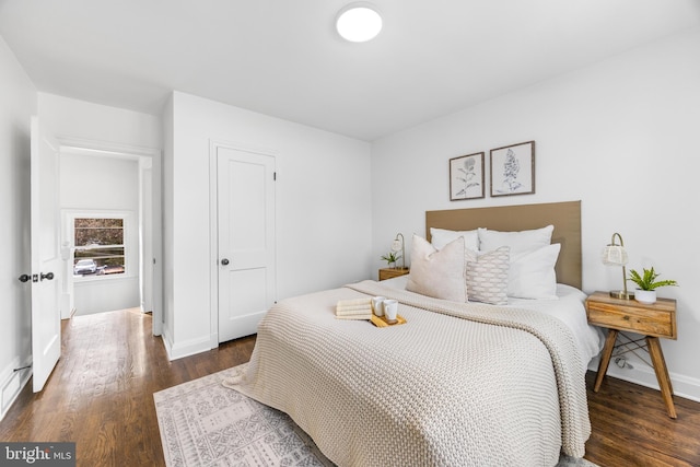 bedroom with dark wood-type flooring