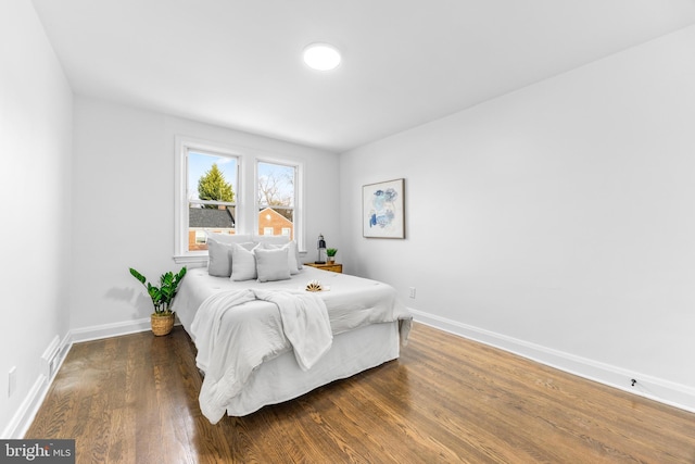 bedroom with dark wood-type flooring