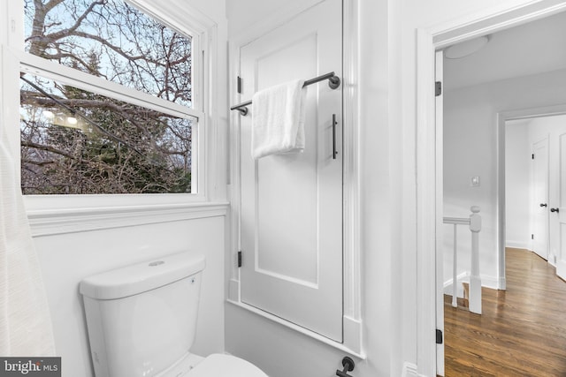 bathroom featuring wood-type flooring and toilet