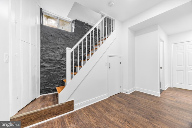 staircase with wood-type flooring