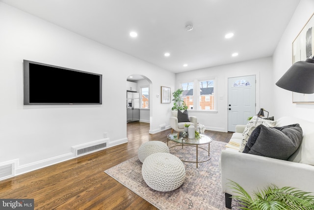 living room with dark hardwood / wood-style flooring