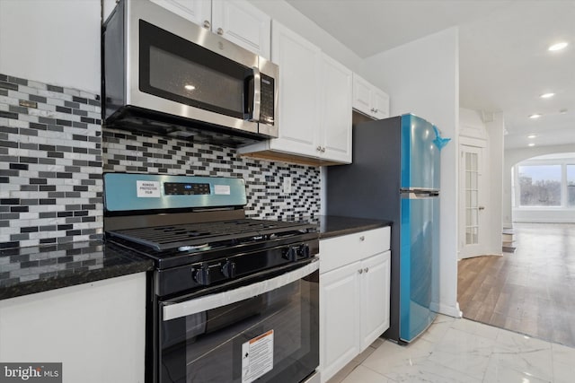 kitchen featuring white cabinetry, tasteful backsplash, and stainless steel appliances