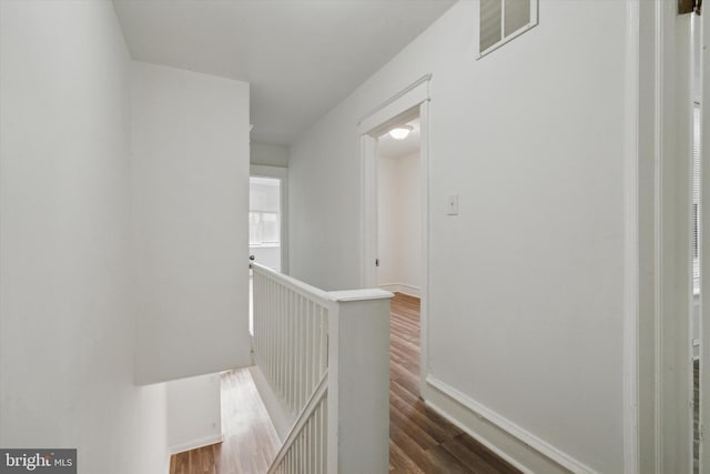 corridor with dark hardwood / wood-style floors