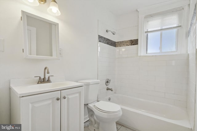 full bathroom featuring vanity, tiled shower / bath combo, and toilet