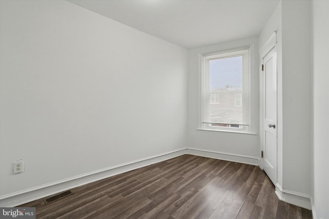 empty room with dark hardwood / wood-style floors