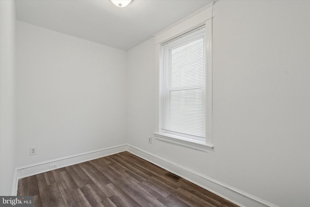 spare room featuring dark hardwood / wood-style flooring