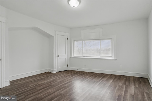 additional living space with dark hardwood / wood-style floors