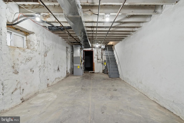 basement with electric water heater and heating unit