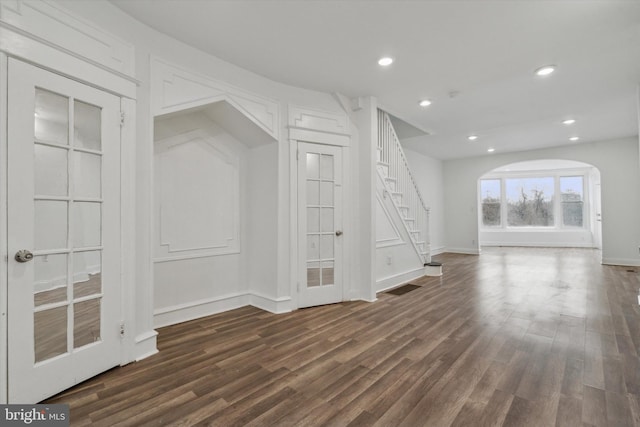 unfurnished living room with dark hardwood / wood-style flooring