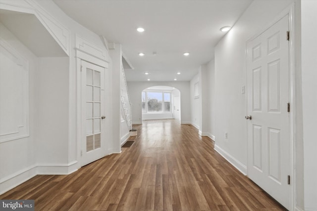 hallway with dark hardwood / wood-style floors