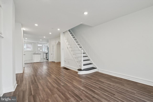 unfurnished living room featuring dark hardwood / wood-style floors