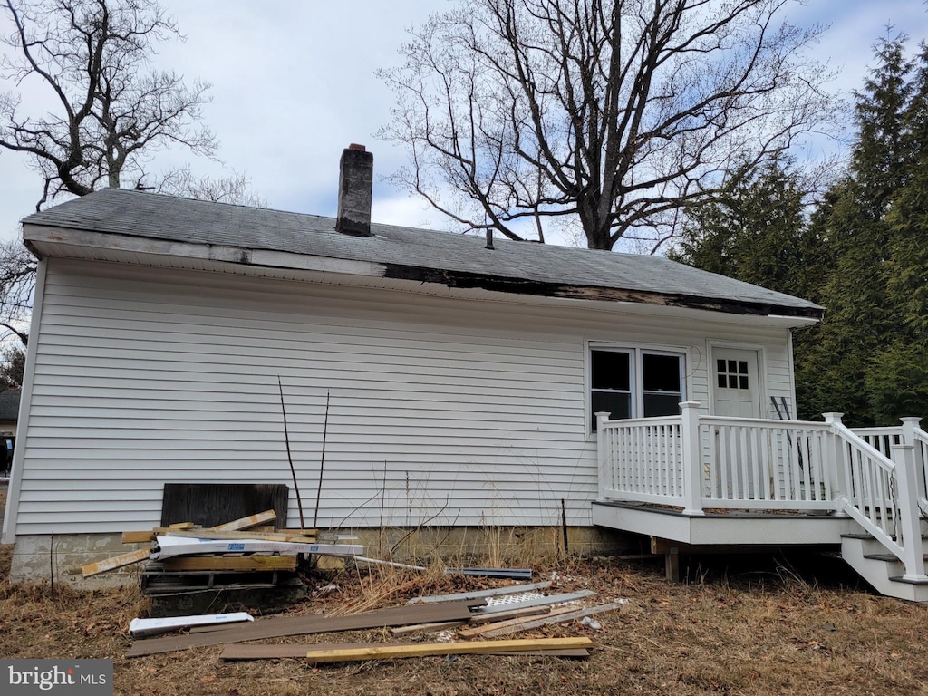 back of property with a wooden deck