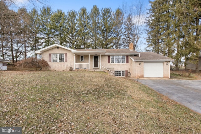 view of front facade with covered porch, a front yard, and a garage