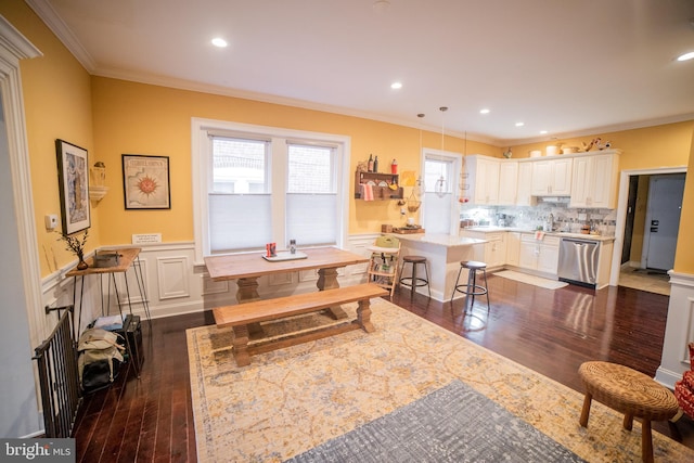 dining room featuring crown molding and dark wood-type flooring