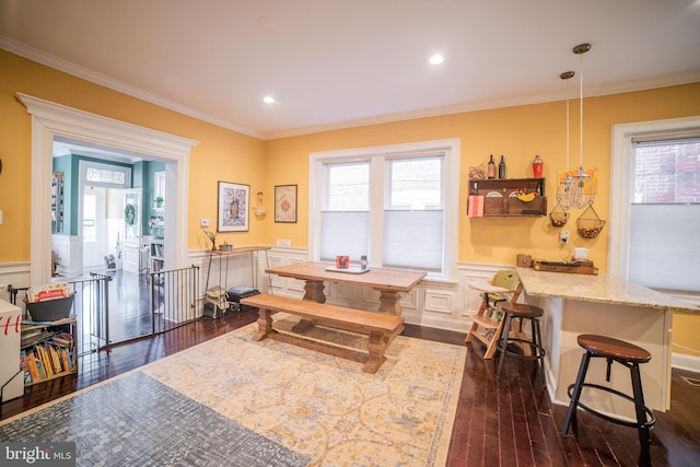 dining space with crown molding and dark hardwood / wood-style floors