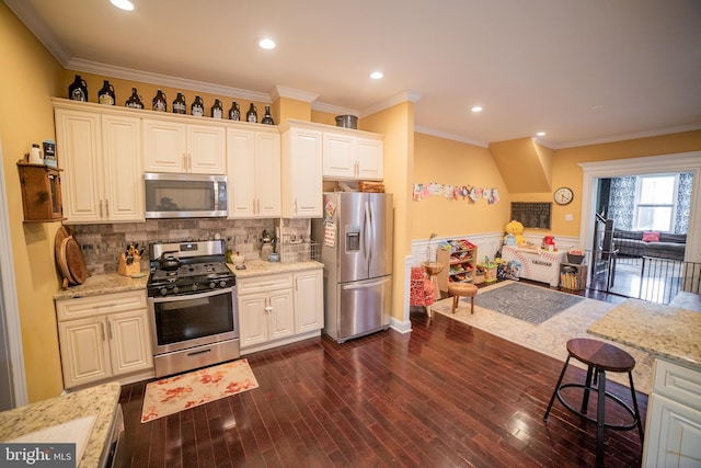 kitchen featuring stainless steel appliances, light stone countertops, and white cabinetry