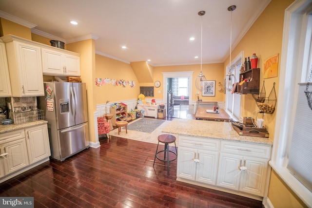 kitchen with stainless steel fridge with ice dispenser, light stone countertops, dark hardwood / wood-style flooring, white cabinetry, and decorative light fixtures