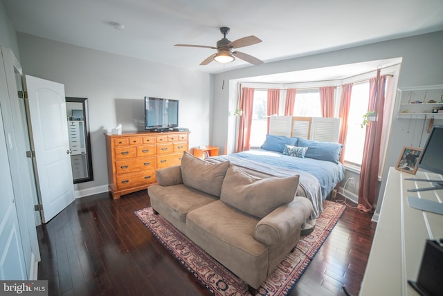 bedroom with ceiling fan and dark hardwood / wood-style floors