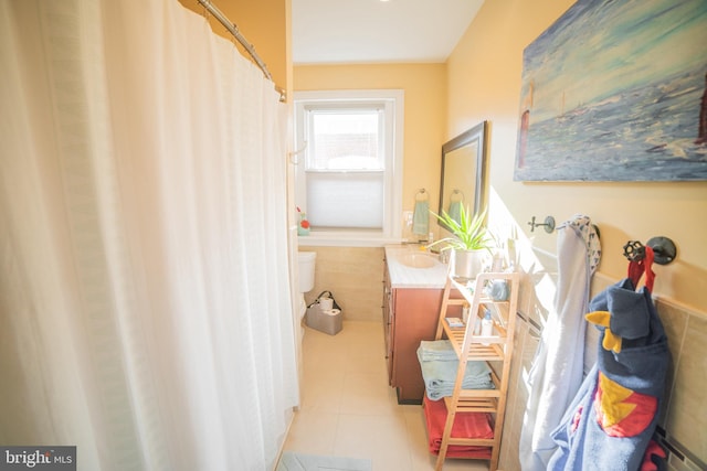 bathroom with tile patterned flooring, vanity, and toilet