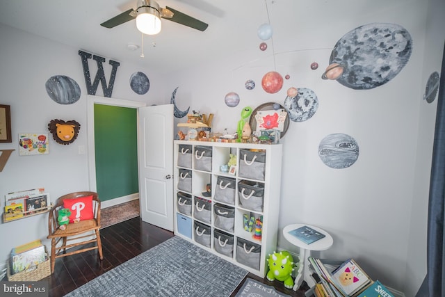 playroom featuring ceiling fan and dark hardwood / wood-style flooring