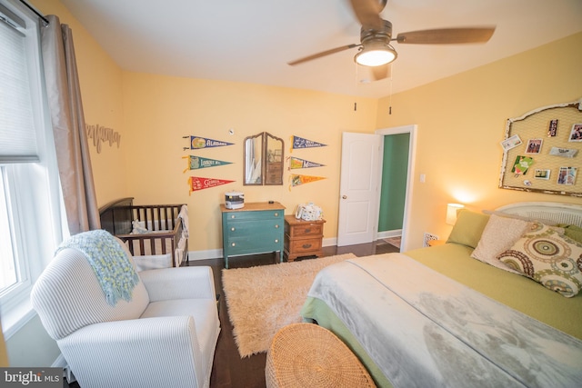 bedroom with ceiling fan and wood-type flooring