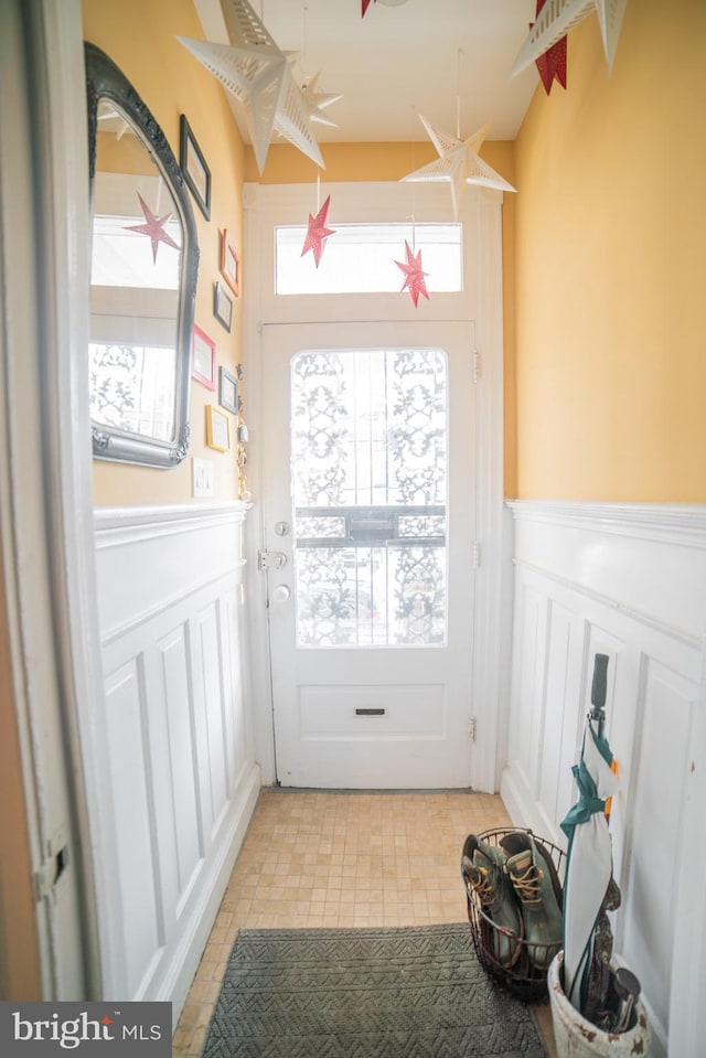 doorway to outside with light tile patterned flooring