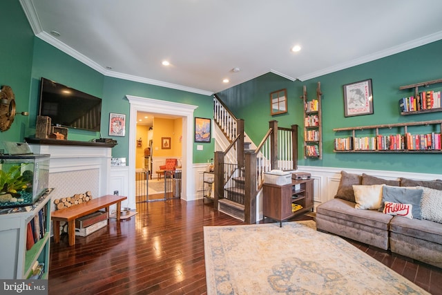 living room featuring ornamental molding, dark hardwood / wood-style flooring, and a fireplace