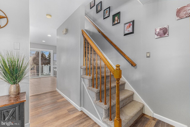 stairs with hardwood / wood-style flooring