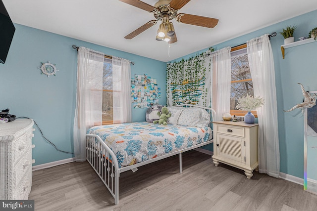 bedroom with ceiling fan and light wood-type flooring