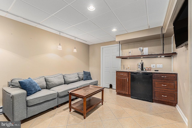 tiled living room featuring a paneled ceiling and indoor bar