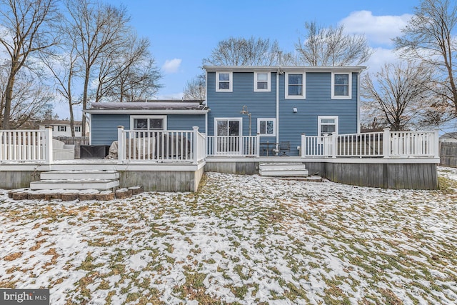 snow covered property with a wooden deck