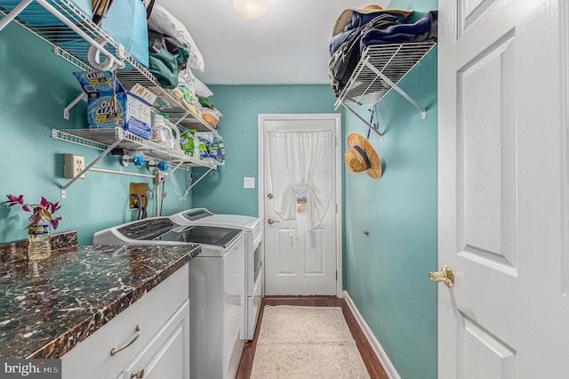 laundry room with washer and dryer and hardwood / wood-style floors