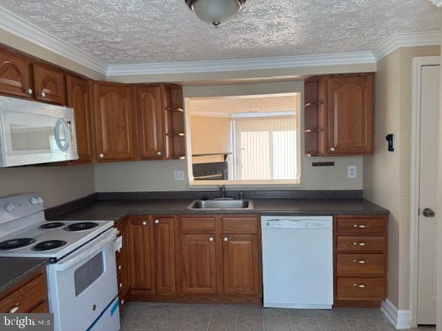 kitchen with a textured ceiling, white appliances, crown molding, and sink