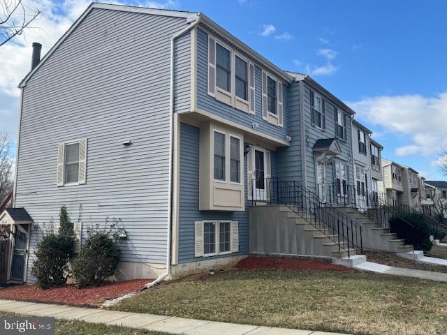 view of property exterior with a yard