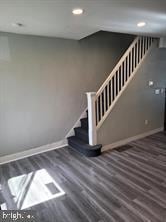 staircase with hardwood / wood-style floors