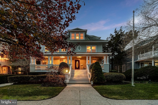 traditional style home with a porch and a front lawn