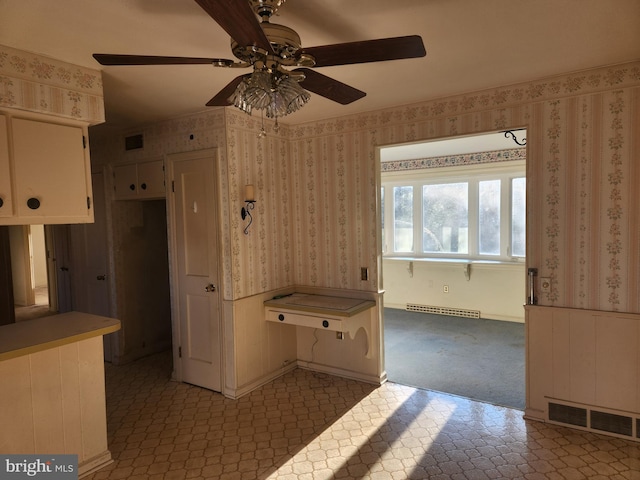 interior space with ceiling fan